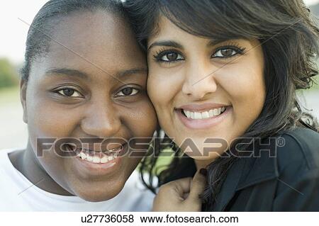 Portrait of two young women smiling View Large Photo Image Stock Photo - Portrait of two young women smiling. Fotosearch