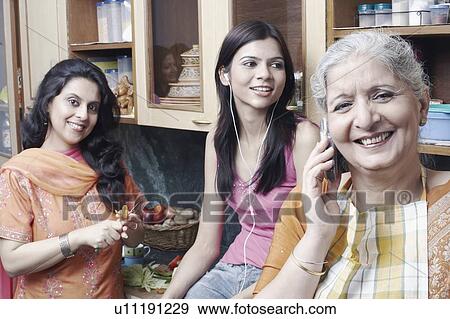 Three women in the kitchen View Large Photo Image Stock Photo - Three women in the kitchen. Fotosearch
