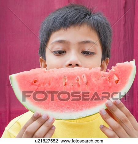 Close-up of a child holding a slice of watermelon View Large Photo Image Stock Image - Close-up of a child holding a slice of watermelon. Fotosearch