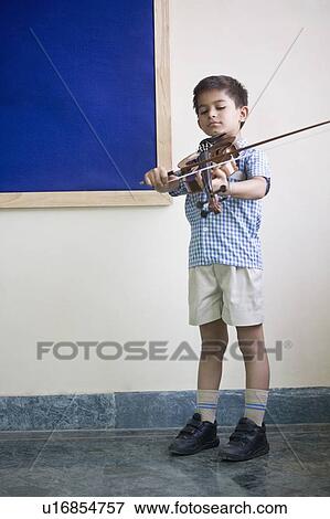 Stock Photo - Close-up of a schoolboy playing a violin. Fotosearch