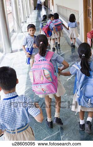 Stock Photography - High angle view of students walking in a corridor. Fotosearch
