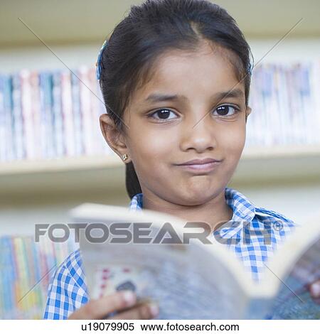 Portrait of a girl holding a book and making a face View Large Photo Image Stock Photography - Portrait of a girl holding a book and making a face. Fotosearch