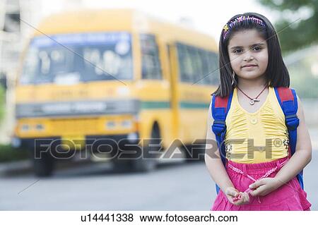 Stock Photo - Portrait of a girl standing on the road. Fotosearch