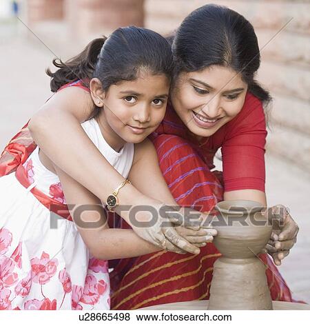 Portrait of a girl with her teacher in a pottery class View Large Photo Image Stock Photo - Portrait of a girl with her teacher in a pottery class. Fotosearch