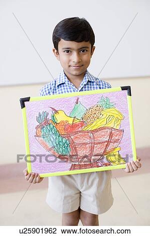 Portrait of a schoolboy holding a painting and smiling View Large Photo Image Stock Image - Portrait of a schoolboy holding a painting and smiling. Fotosearch