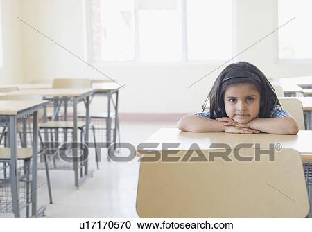Portrait of a schoolgirl leaning on a desk in a classroom View Large Photo Image Stock Image - Portrait of a schoolgirl leaning on a desk in a classroom. Fotosearch