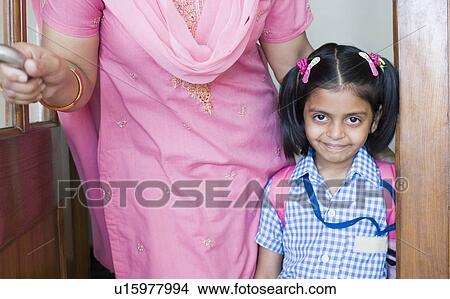 Portrait of a schoolgirl standing beside her teacher View Large Photo Image Picture - Portrait of a schoolgirl standing beside her teacher. Fotosearch