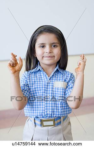 Portrait of a schoolgirl with her fingers crossed View Large Photo Image Picture - Portrait of a schoolgirl with her fingers crossed. Fotosearch