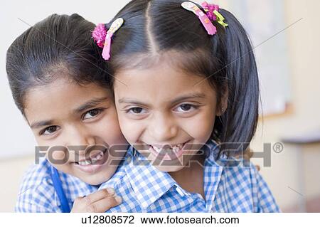 Portrait of two schoolgirls smirking View Large Photo Image Stock Image - Portrait of two schoolgirls smirking. Fotosearch