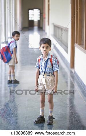 Stock Photo - Portrait of a boy standing in the corridor of a school. Fotosearch