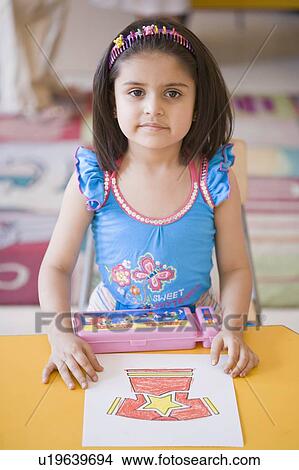 Portrait of a girl with her drawing in the classroom View Large Photo Image Picture - Portrait of a girl with her drawing in the classroom. Fotosearch