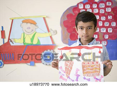 Portrait of a schoolboy holding a drawing and smiling View Large Photo Image Stock Image - Portrait of a schoolboy holding a drawing and smiling. Fotosearch