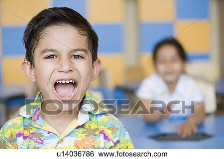 Portrait of a schoolboy shouting View Large Photo Image Stock Photograph - Portrait of a schoolboy shouting. Fotosearch