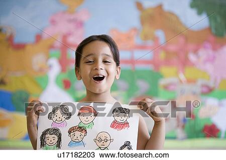 Portrait of a schoolgirl holding a drawing and making a face View Large Photo Image Stock Image - Portrait of a schoolgirl holding a drawing and making a face. Fotosearch