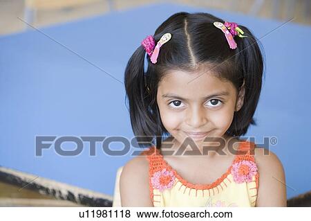 Stock Photo - Portrait of a schoolgirl smiling. Fotosearch