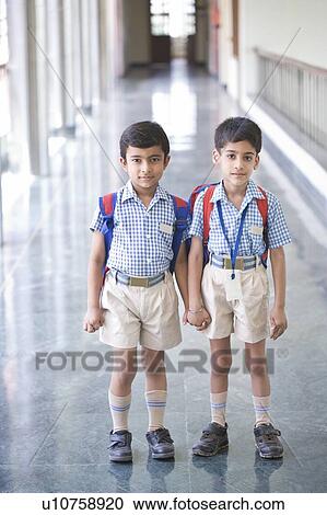 Portrait of two boys standing in a corridor with holding hands of each other View Large Photo Image Stock Image - Portrait of two boys standing in a corridor with holding hands of each other. Fotosearch