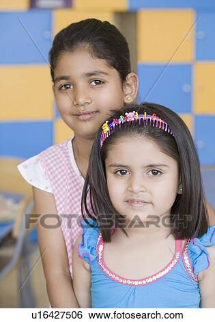 Stock Photograph - Portrait of two girls smiling. Fotosearch