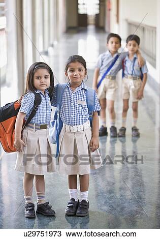 Portrait of two schoolgirls standing in a corridor View Large Photo Image Stock Image - Portrait of two schoolgirls standing in a corridor. Fotosearch