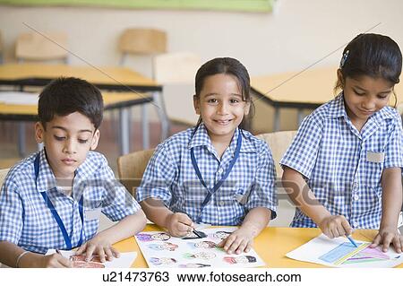 School children drawing in a classroom View Large Photo Image Stock Image - School children drawing in a classroom. Fotosearch
