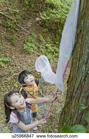 Boy and Girl Catching Insects View Large Photo Image Stock Photo - Boy and Girl Catching Insects. Fotosearch