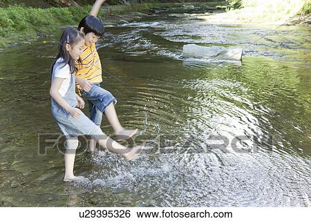 Boy and Girl Playing with Water View Large Photo Image Stock Photograph - Boy and Girl Playing with Water. Fotosearch