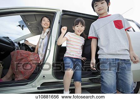 Stock Photograph - Children Getting Out of a Car. Fotosearch