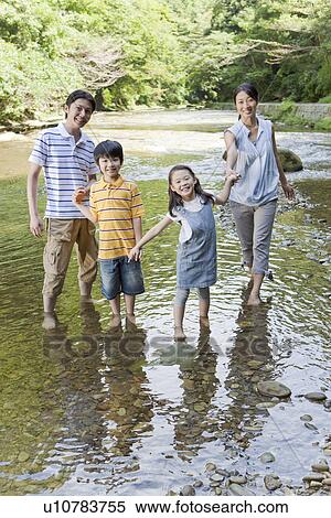 Stock Photography - Family Playing with Water. Fotosearch