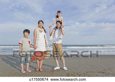 Picture - Family Standing at Beach. Fotosearch