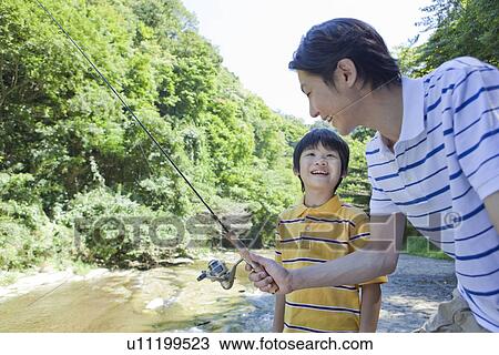 Stock Image - Father and Son Enjoying Fishing. Fotosearch