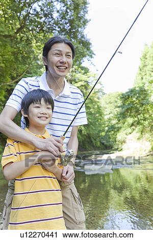 Stock Image - Father and Son Enjoying Fishing. Fotosearch