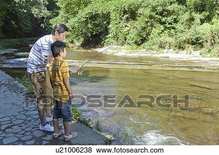 Stock Photo - Father and Son Enjoying Fishing. Fotosearch