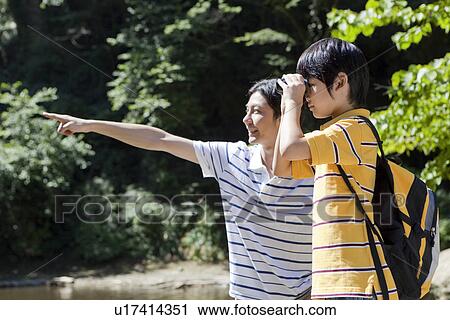 Stock Image - Father and Son Using Binoculars. Fotosearch