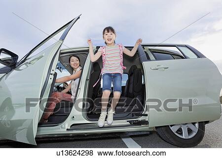 Stock Photo - Girl Jumping Out of a Car. Fotosearch