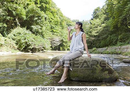 Young Woman Drinking Water at River View Large Photo Image Stock Image - Young Woman Drinking Water at River. Fotosearch