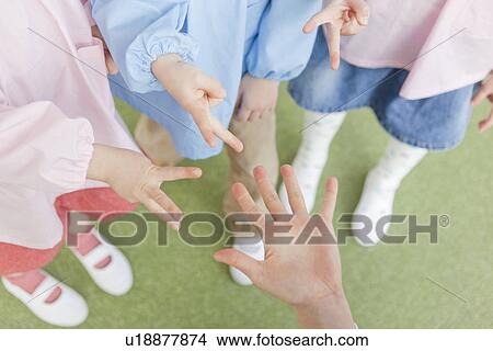 Hands of Kindergarten Children Playing Rock-paper-scissors View Large Photo Image Picture - Hands of Kindergarten Children Playing Rock-paper-scissors. Fotosearch