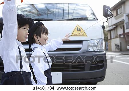Picture - Kindergarten Children Holding Up Hands in front of School Bus. Fotosearch