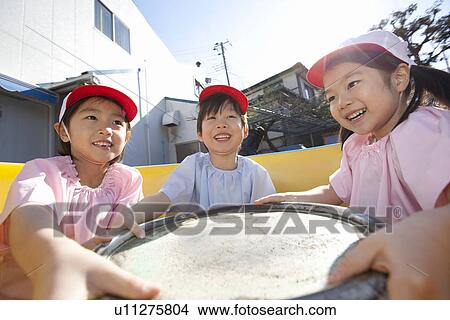 Picture - Kindergarten Children Playing with Play Equipment. Fotosearch