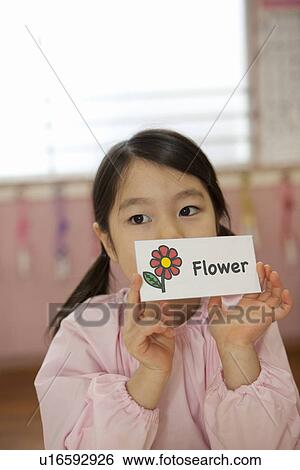 Stock Photograph - Kindergarten Girl Holding Picture Card. Fotosearch
