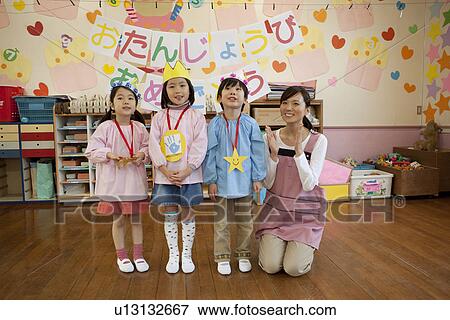 Kindergarten Teacher and Children Celebrating Birthday View Large Photo Image Stock Photo - Kindergarten Teacher and Children Celebrating Birthday. Fotosearch