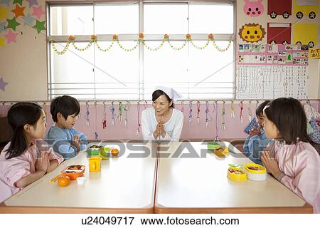 Kindergarten Teacher and Children Having Lunch View Large Photo Image Stock Photo - Kindergarten Teacher and Children Having Lunch. Fotosearch