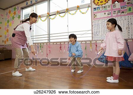 Kindergarten Teacher and Children Playing Rope Jumping View Large Photo Image Stock Photograph - Kindergarten Teacher and Children Playing Rope Jumping. Fotosearch