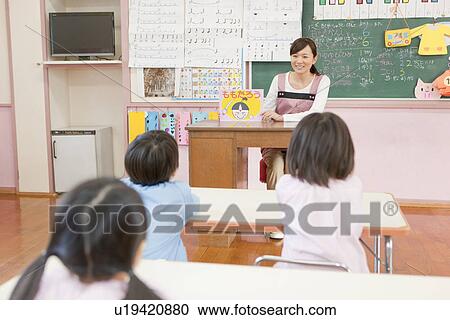 Kindergarten Teacher Showing Picture Card Show to Children View Large Photo Image Stock Image - Kindergarten Teacher Showing Picture Card Show to Children. Fotosearch