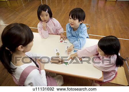 Stock Image - Kindergarten Teacher Teaching Children. Fotosearch