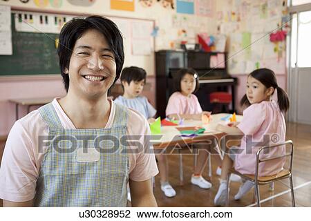 Stock Image - Kindergarten Teacher with Children. Fotosearch