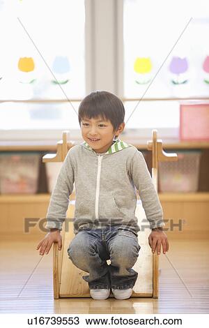 Stock Image - Boy Playing Slide. Fotosearch