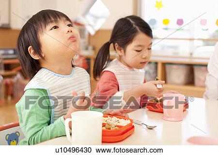 Stock Image - Children Eating School Lunch. Fotosearch