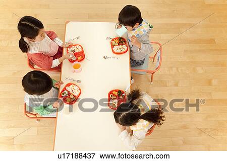 Stock Photo - Children Eating School Lunch. Fotosearch