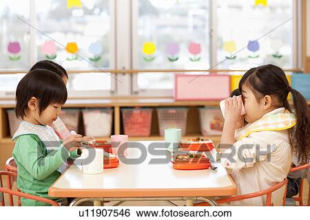 Stock Photograph - Children Eating School Lunch. Fotosearch
