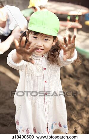 Stock Image - Girl Playing with Sand. Fotosearch