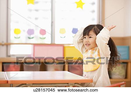 Stock Photography - Girl Putting Hands Up. Fotosearch